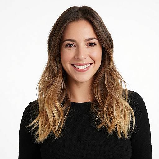 Photograph of a smiling young woman with long, wavy, ombre hair, wearing a black top, against a plain white background.