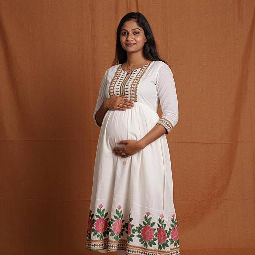 Pregnant Indian Woman in Traditional White Dress