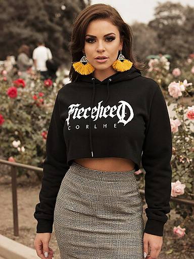 Toned woman in streetwear with statement earrings