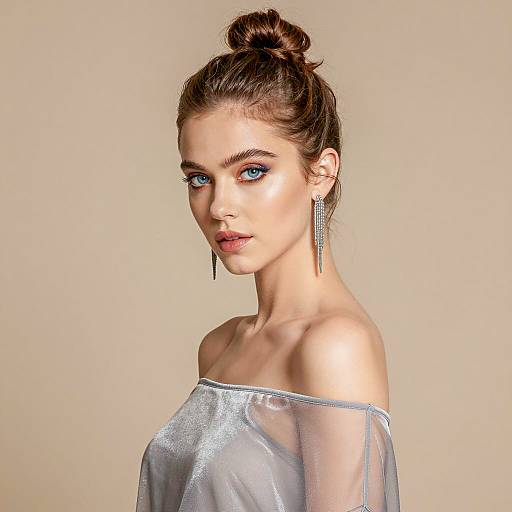 Portrait of woman with high bun and silver-gray top