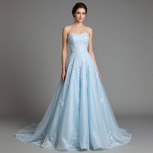 Photograph of a fair-skinned woman with dark hair in an elegant, strapless, light blue, lace-embellished wedding gown with a