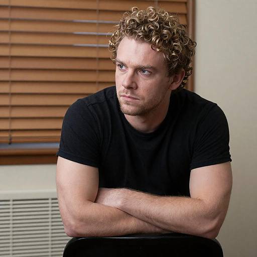 Muscular Man with Curly Blonde Hair in Black T-shirt