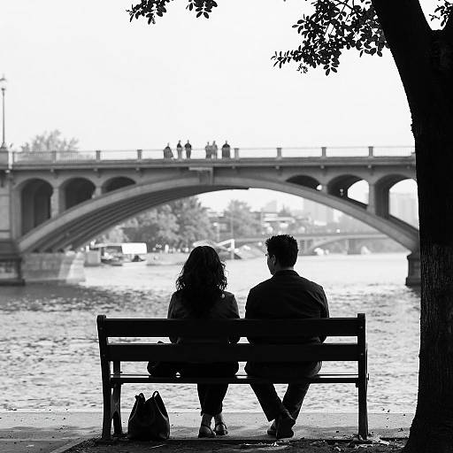 Silhouetted Figures Under a Bridge