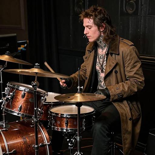 Tattooed Drummer in Dimly Lit Room