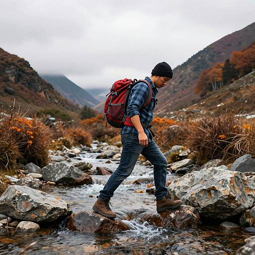 Autumn Hiker Crossing Mountain Stream