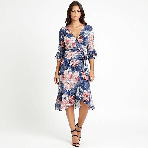 Photograph of a dark-haired woman in a blue floral wrap dress with pink and white flowers, V-neck, 3/4 sleeves, and black