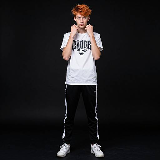 Photograph of a young boy with orange hair, wearing a white 