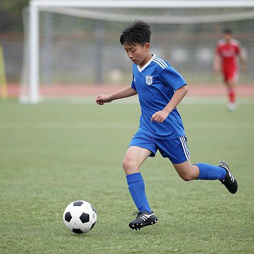 Child Playing Soccer Outdoors