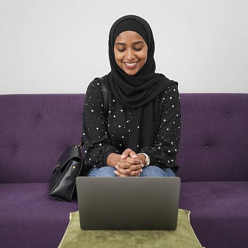 Smiling Woman in Black Hijab on Sofa