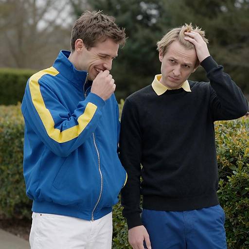 Two Men Standing Outdoors in Casual Clothing