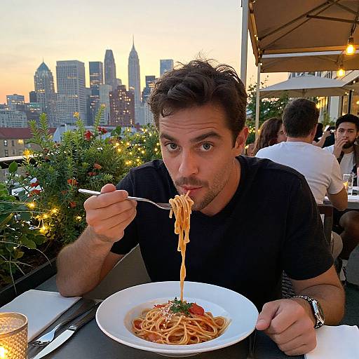 Man Enjoying Pasta on Rooftop Patio
