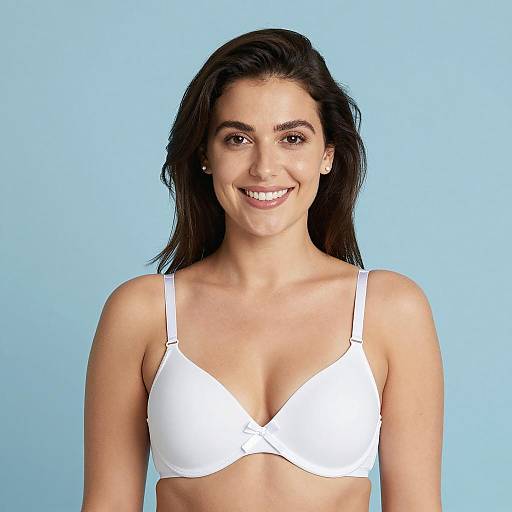 Smiling woman in white bra against blue background