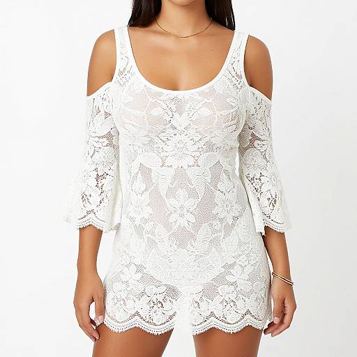 Photograph of a woman wearing a white, lace, off-shoulder mini dress with three-quarter sleeves, against a plain white background.