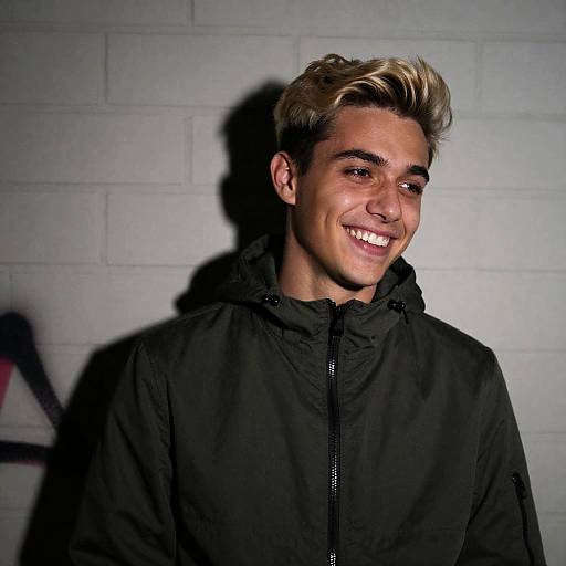 Young Man Smiling Against Graffiti Wall