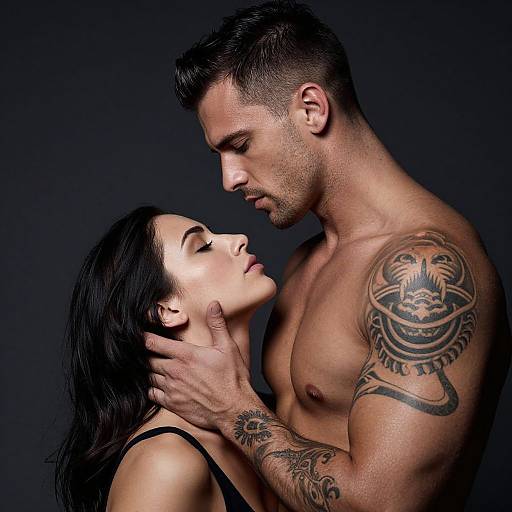 Photograph of a muscular, tattooed man with short dark hair, gazing intensely at a woman with long black hair, wearing a black tank top