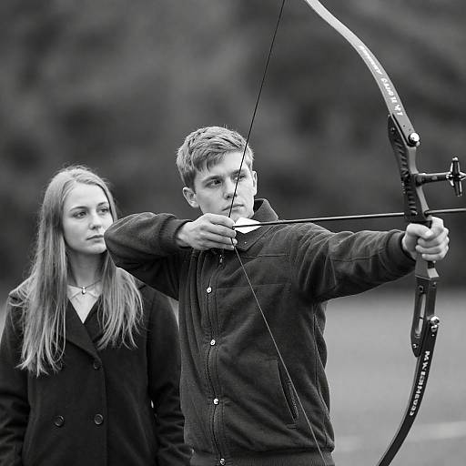 Young Man Practicing Archery with Woman Observing