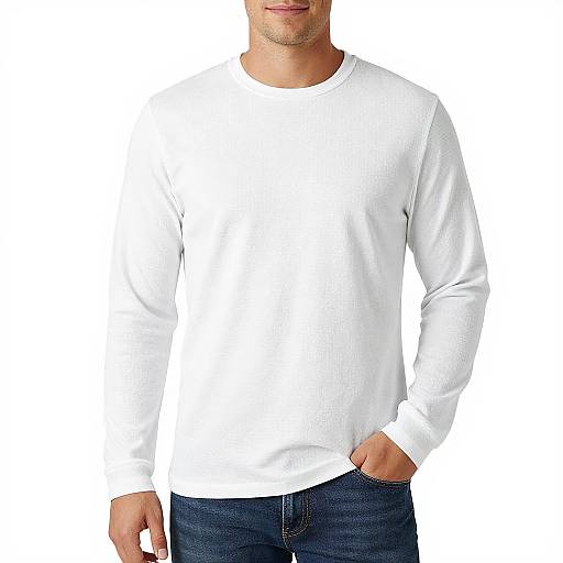 Photograph of a man in a plain white long-sleeve shirt and dark blue jeans, hand in pocket, white background.