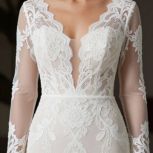 Photograph of a woman wearing an elegant white lace wedding dress with a deep V-neck and sheer long sleeves.