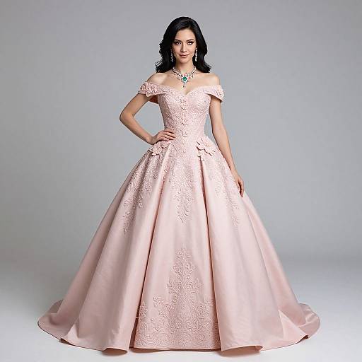 Photograph of a confident woman with long black hair, wearing an off-the-shoulder, pink satin ball gown with intricate embroidery, standing against a