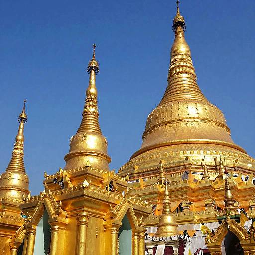 Golden Buddhist Stupas in Sunlight