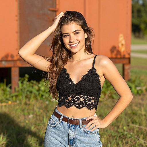 Smiling young woman in black lace crop top outdoors