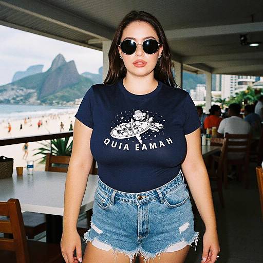 Photograph of a curvy Latina woman with long dark hair, wearing black sunglasses, black 