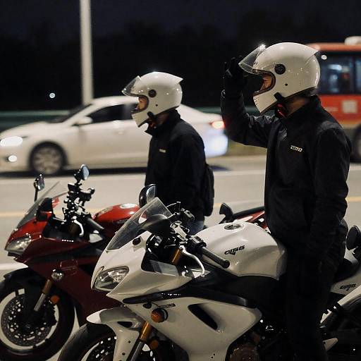 Two Motorcyclists Standing at Night