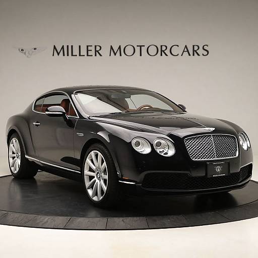 Photograph of a sleek black Maserati sedan with chrome accents, polished wheels, and 