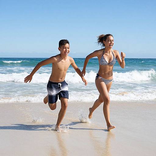 Young couple jogging on a sunny beach, wearing black-and-white striped bikini and black board shorts, with waves and clear blue sky in the background.