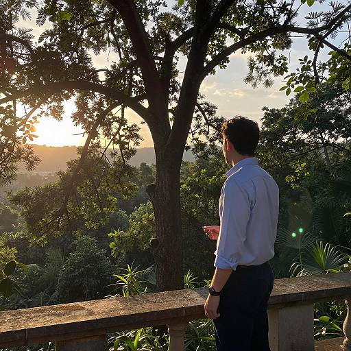 Man Standing on Balcony at Sunset