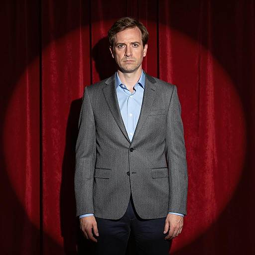 Stylish Man in Spotlight with Curtain