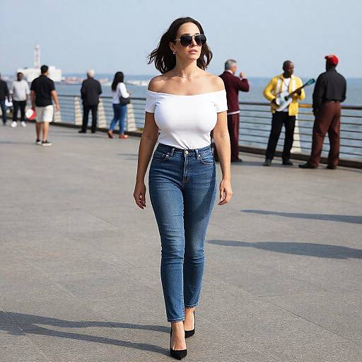 Photograph of a confident woman with dark hair, wearing an off-shoulder white top, blue jeans, black heels, and sunglasses, walking on