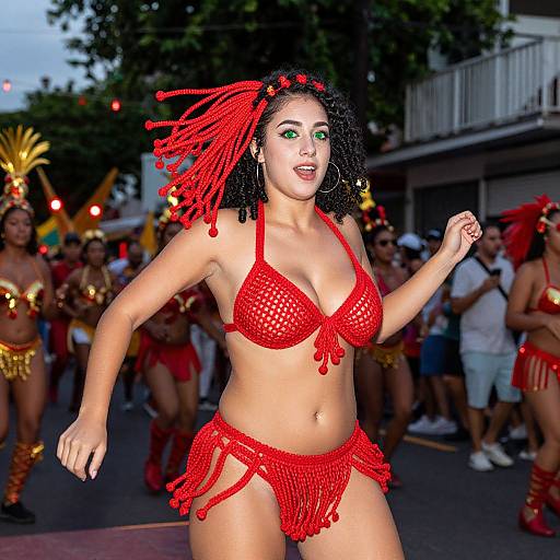 Photograph of a curvy woman with dark skin and green eyes, wearing a red beaded bikini and matching red headpiece, dancing energetically