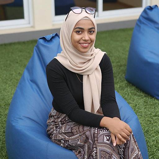 Smiling Woman in Beige Hijab Sitting
