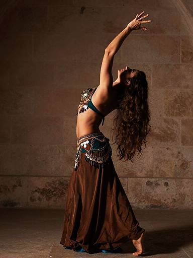 Graceful Belly Dancer in Bronze and Teal Costume