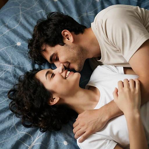 Intimate Moment on Blue Patterned Bed