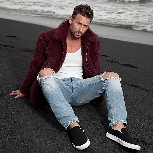 Photograph of a handsome, bearded man with spiked brown hair, wearing a maroon fur coat, white tank top, ripped jeans, and black