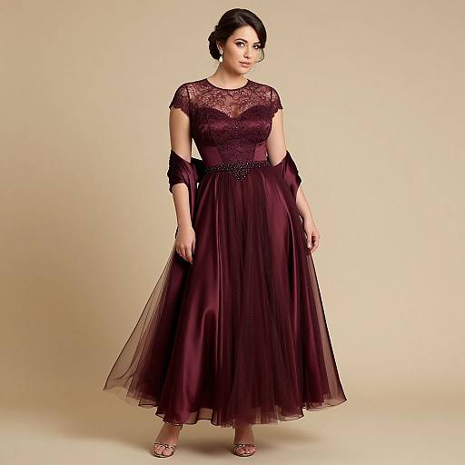 Photograph of a young woman with fair skin and dark hair in an elegant, sheer, dark purple lace and tulle evening gown.