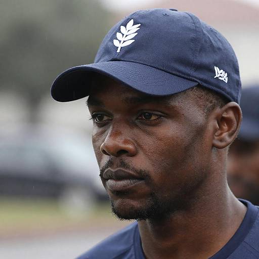 Close-Up of a Serious Black Man in Rain