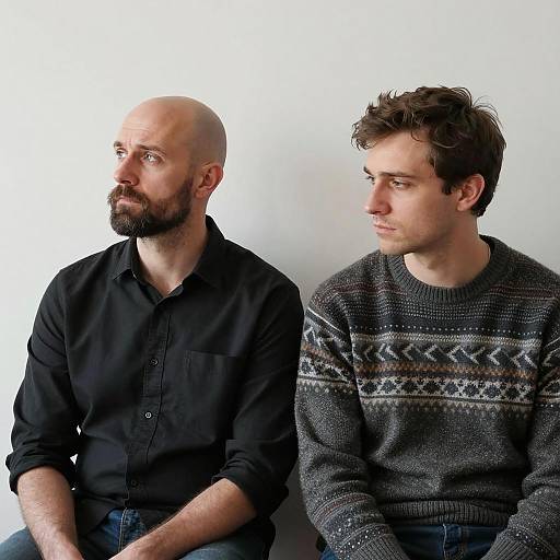 Serious Men in Contrast Against White Wall