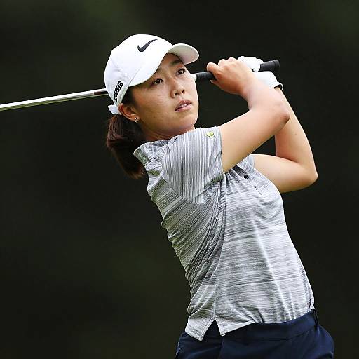 Dynamic Female Golfer Mid-Swing