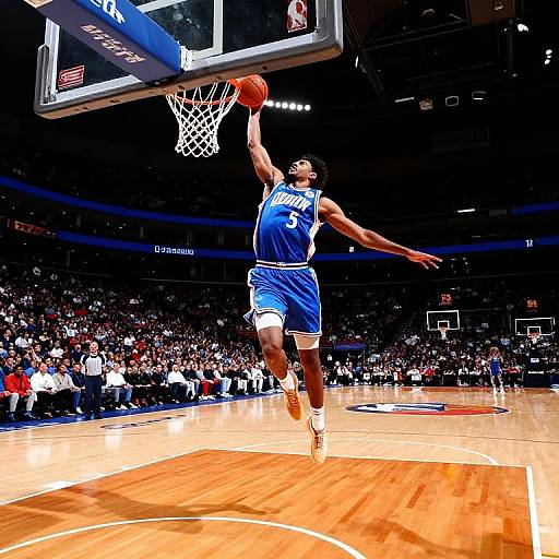 Photograph of a muscular African-American male basketball player in a blue Los Angeles Lakers jersey, mid-air, dunking a basketball against a brightly lit indoor