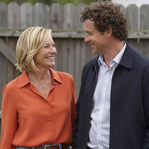 Smiling Couple Outdoors by Fence