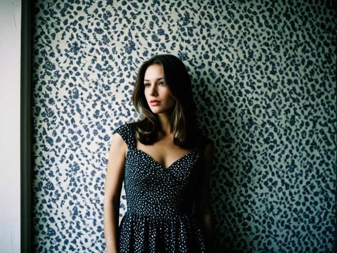 Elegant Woman Close-Up Against Wall