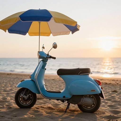 Photograph of a light blue scooter with a yellow-blue beach umbrella, on a sandy beach at sunset, ocean in background.