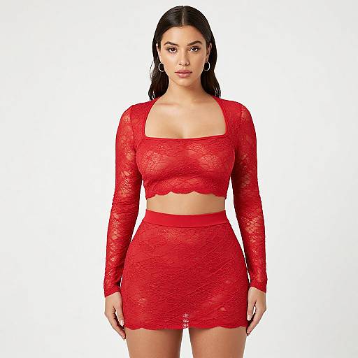 Photograph of a woman with long black hair, wearing a red lace long-sleeve crop top and matching high-waisted mini skirt, standing