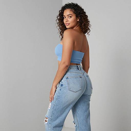 Curvy woman in blue bandeau top and ripped jeans