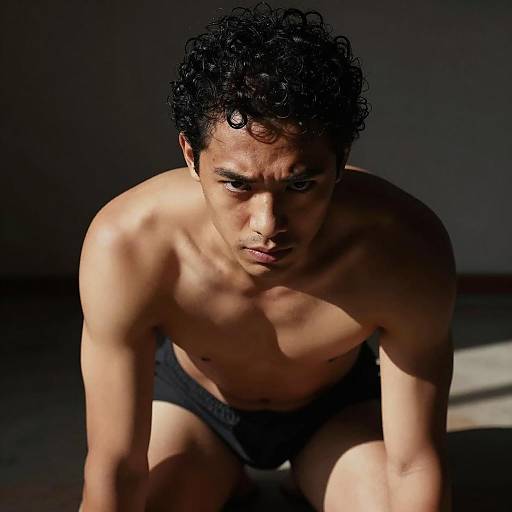 Focused Man in Dimly Lit Room