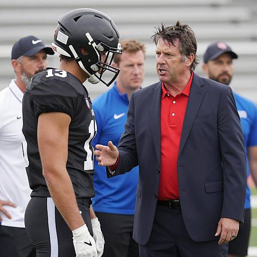 Focused Coach and Football Player Interaction