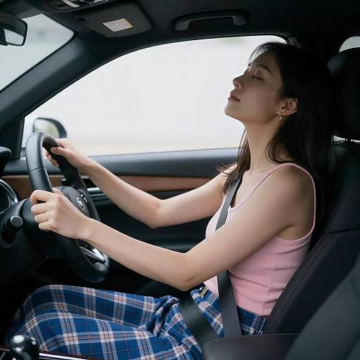 Asian Woman Resting in Dim Car